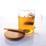 Transparent glass mug with eco-friendly bamboo lid and spoon